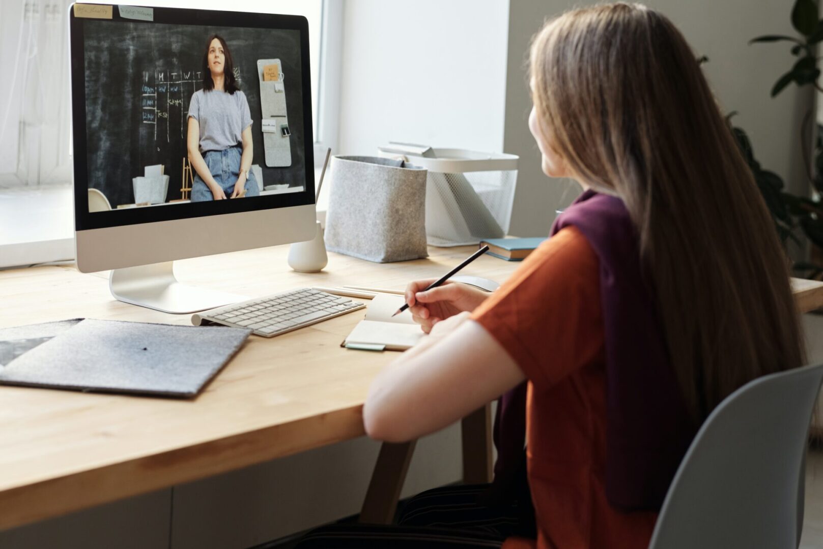 A woman sitting at her desk in front of a computer.